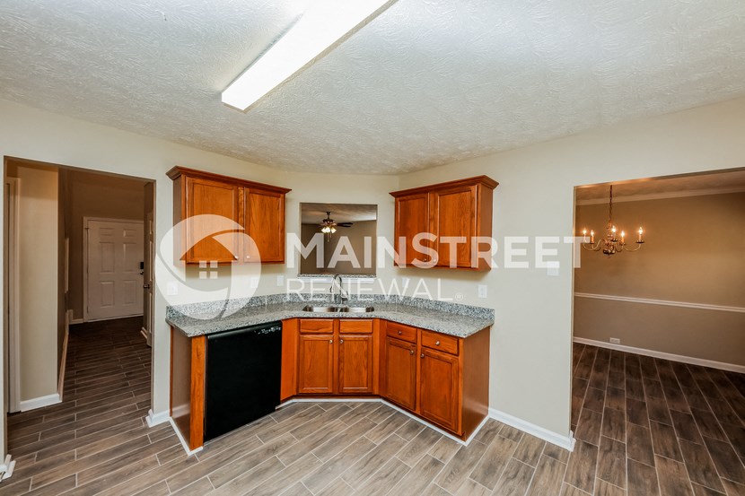 a kitchen with wooden cabinets and a counter top