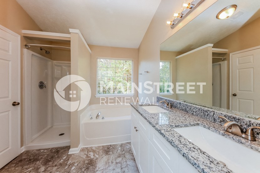 a bathroom with a sink and a tub and a shower