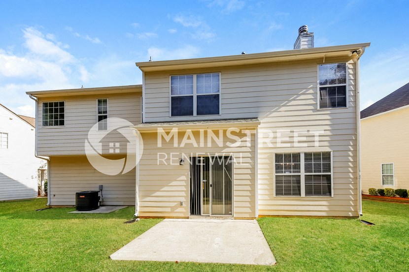a renovated house with a front yard and a driveway