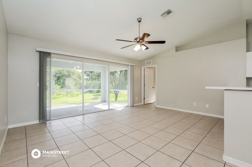 the spacious living room with sliding glass doors to the patio