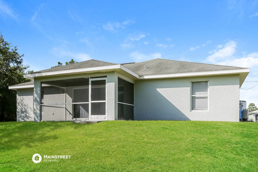 a white house with a lawn in front of it