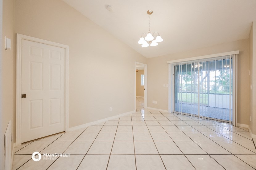 an empty living room with a door to a patio