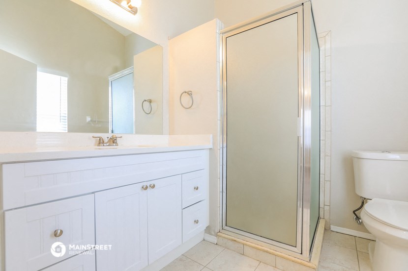 a bathroom with a shower and a sink and a toilet