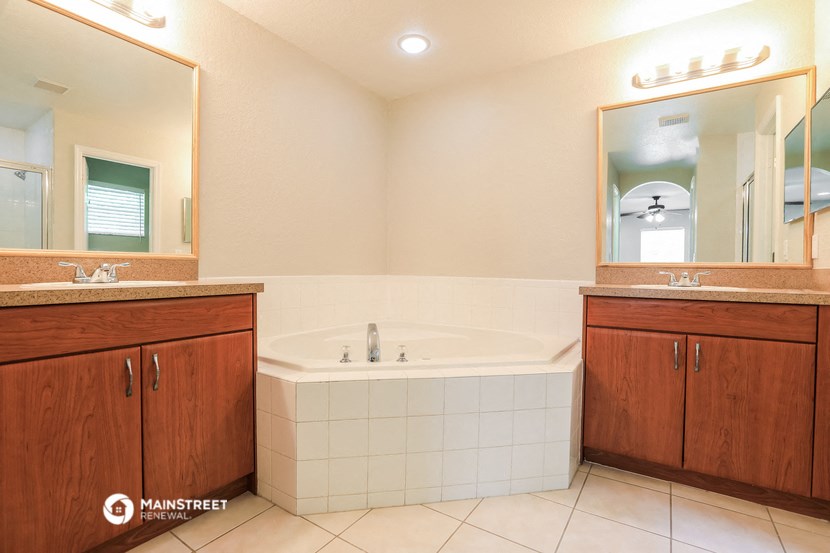 a bathroom with a jacuzzi tub and two sinks