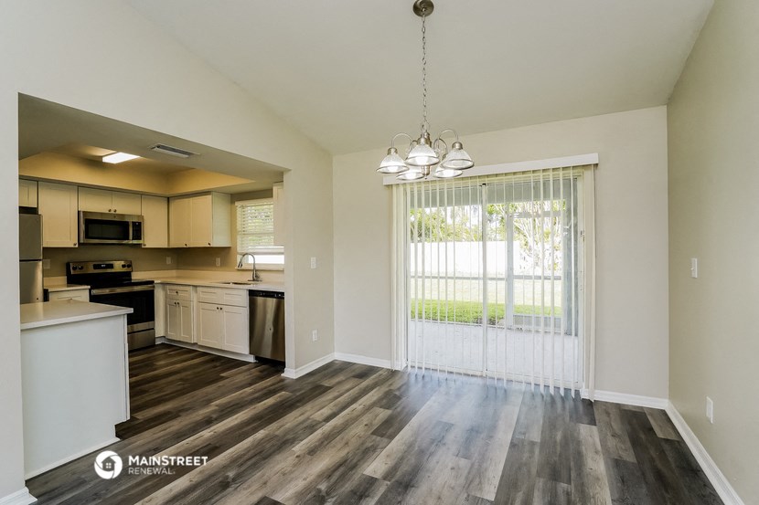 an open kitchen with a sliding glass door to the yard
