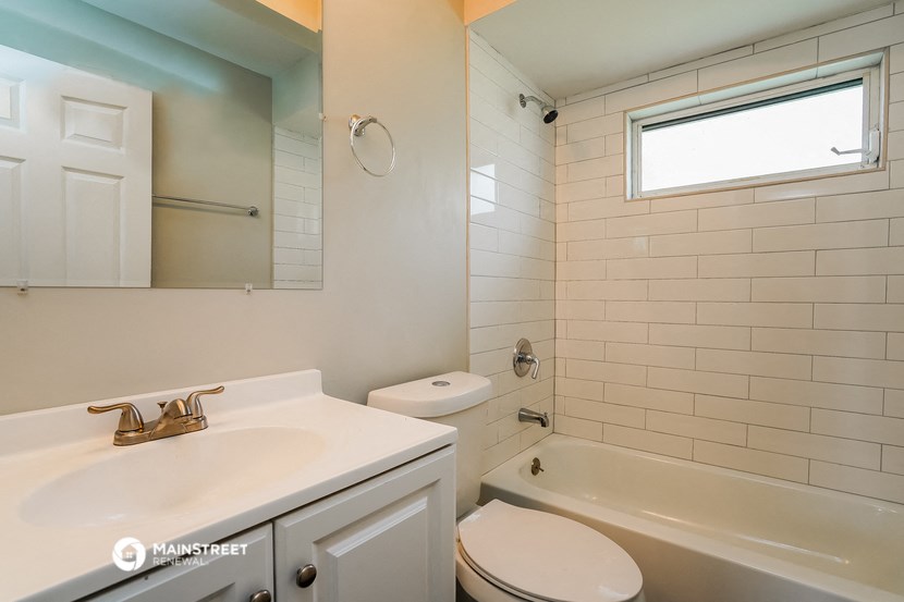 a bathroom with a sink and a toilet and a bath tub