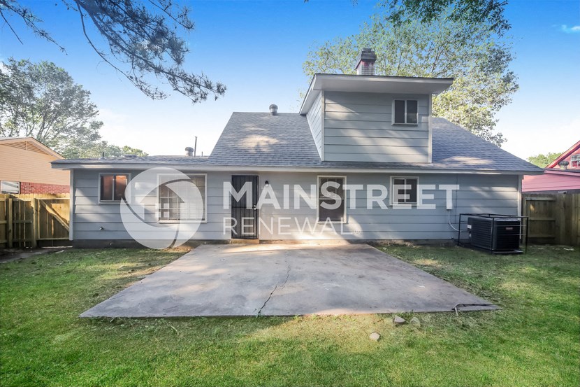 a side view of a house with a garage and a driveway