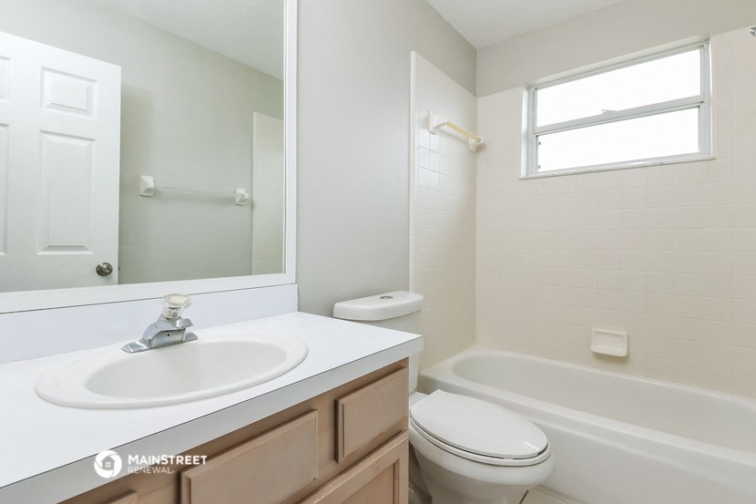 a bathroom with a sink and a toilet and a tub