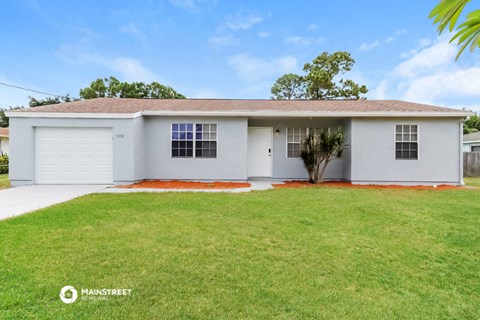 a white house with a lawn in front of it