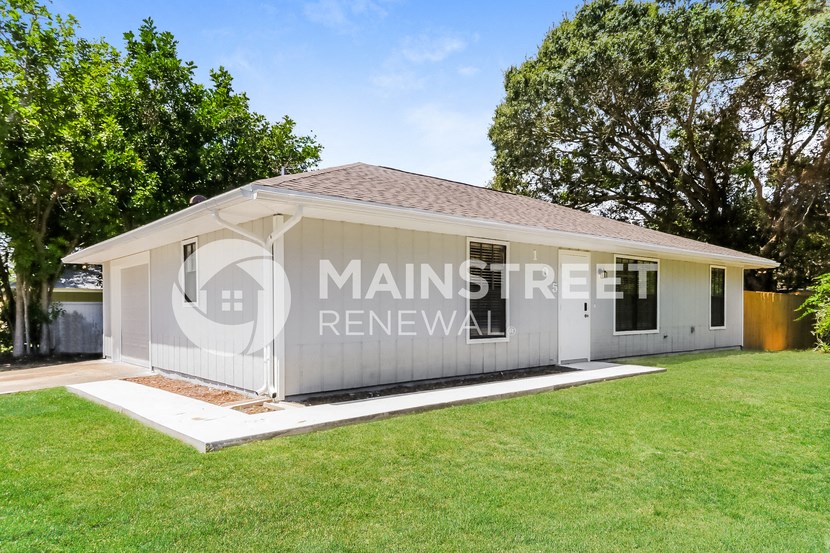 a manufactured home with a garage and a lawn