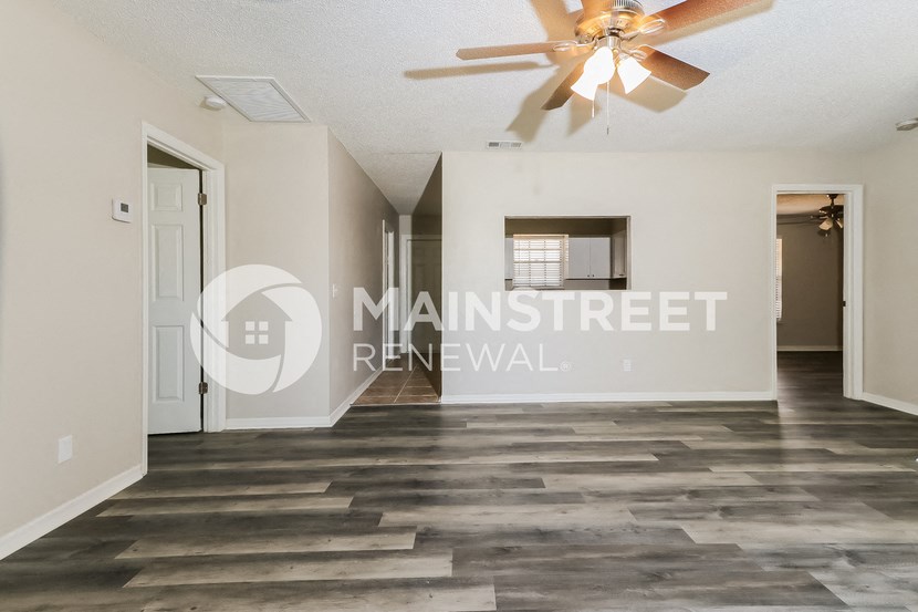 a renovated living room and a staircase