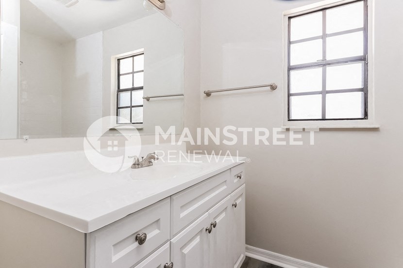 two closets in a bathroom with white cabinets and a white counter top