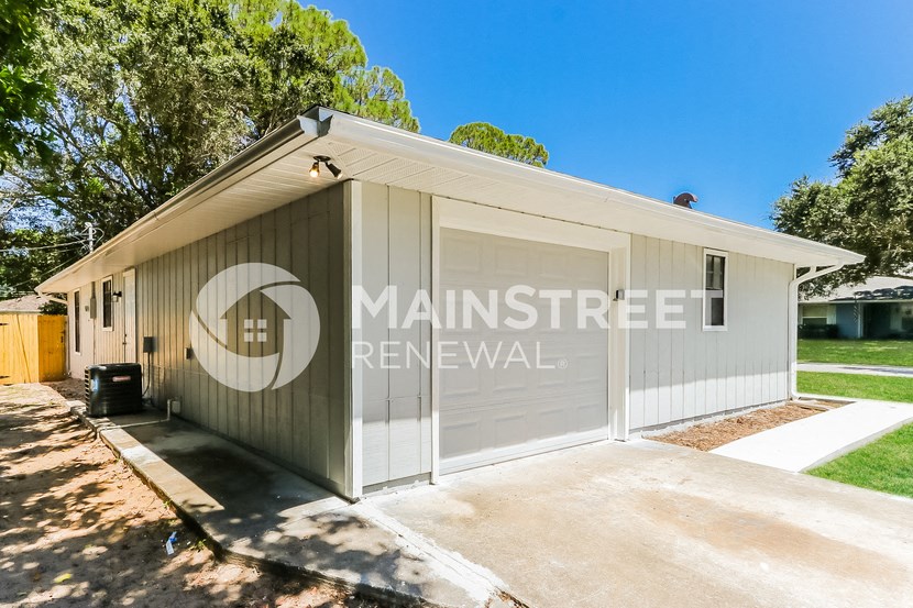 a small garage with a garage door on the side of it