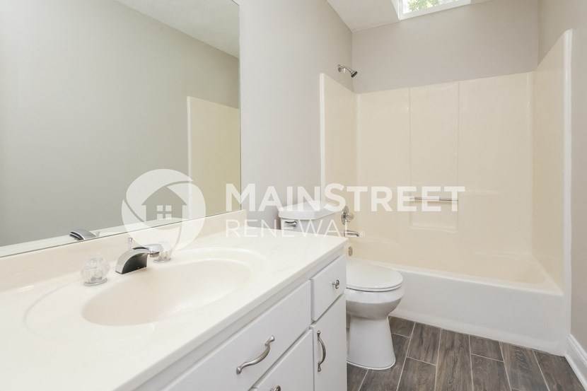 a renovated bathroom with a toilet and a sink