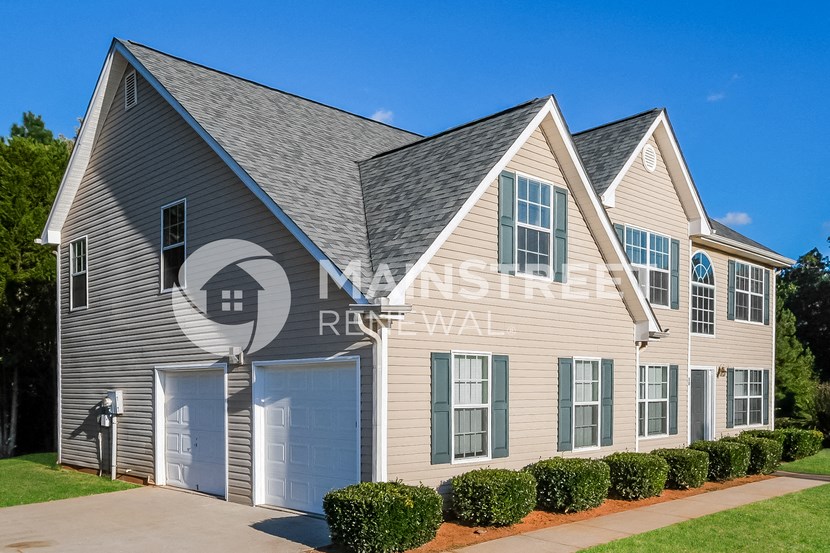 a house with two garage doors and a driveway