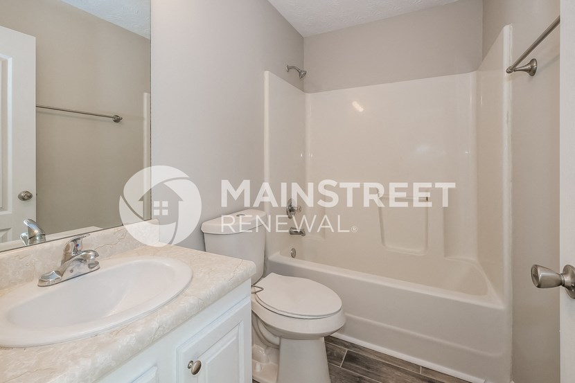 a bathroom with a sink toilet and a tub