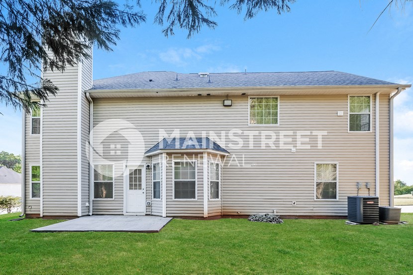 a white house with a lawn in front of it