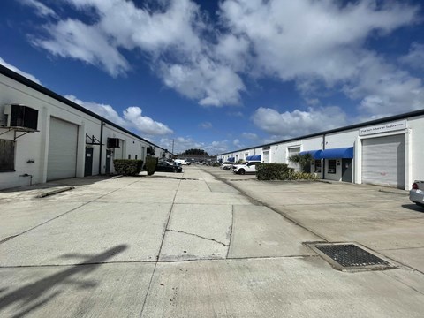 a row of garages on the side of a street