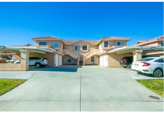 a row of houses with cars parked in the driveway