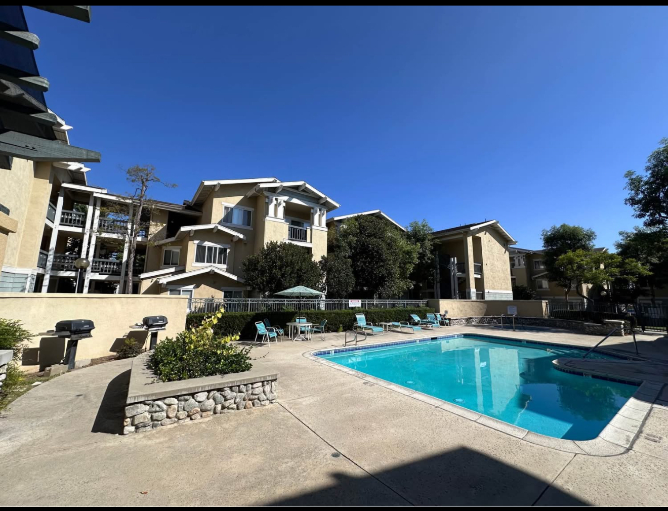 A swimming pool in front of a residential building.
