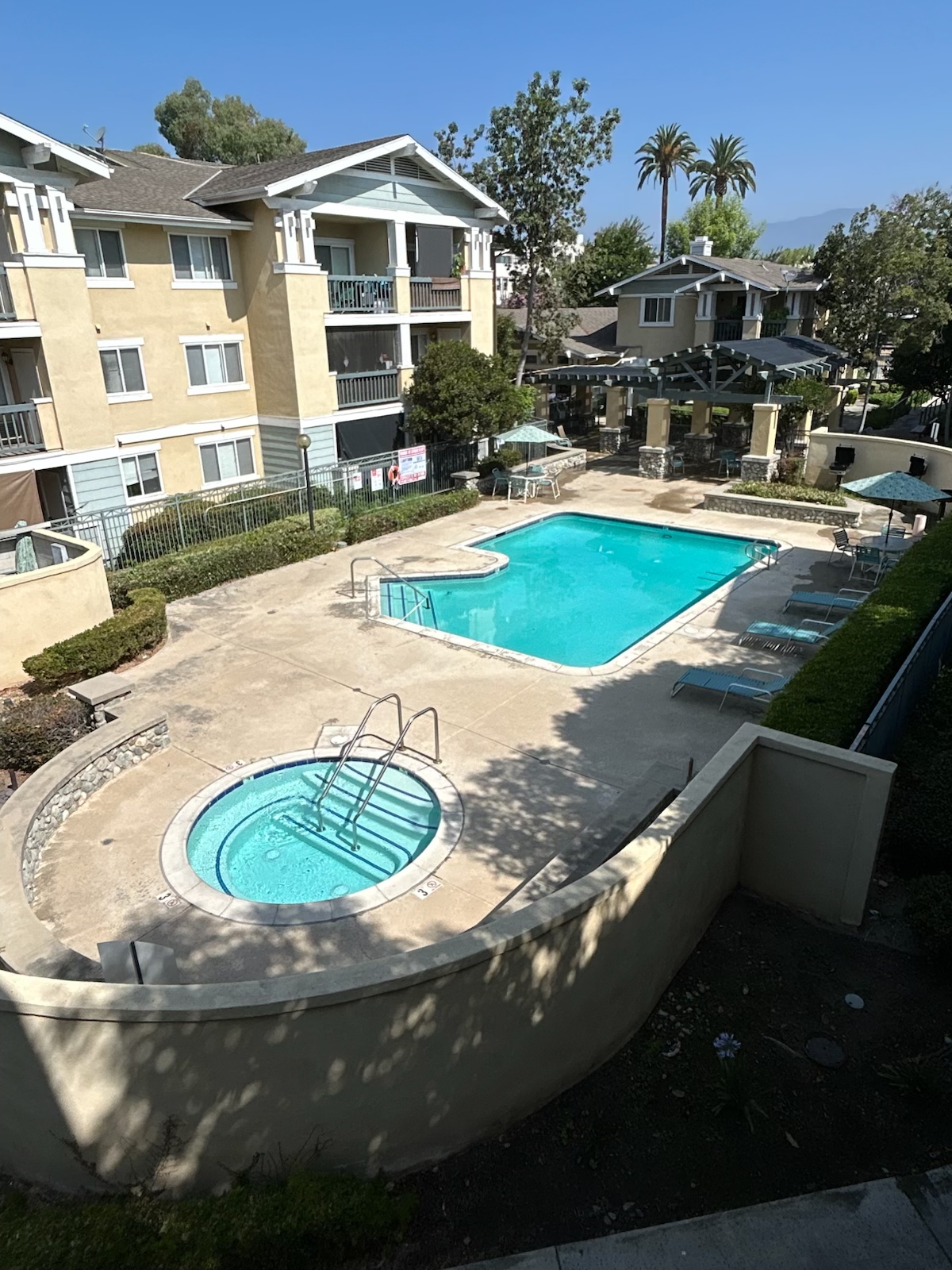 A swimming pool with a hot tub in the middle of it.