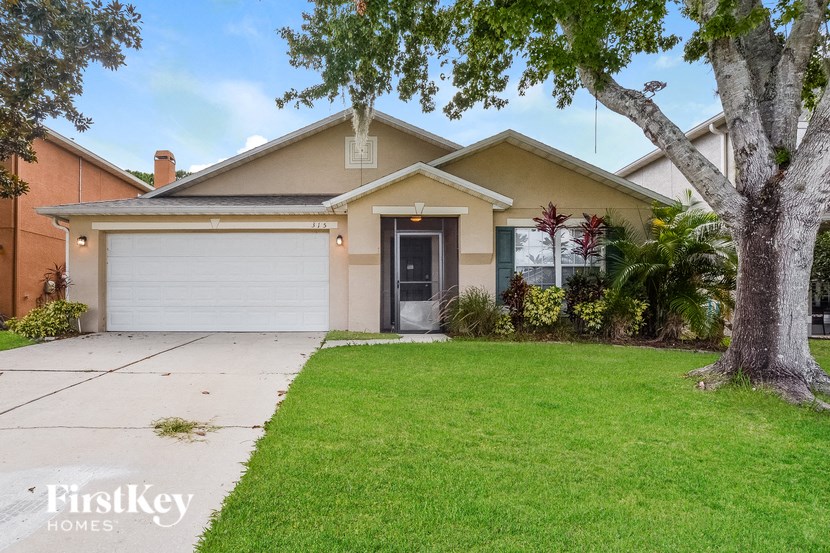 A house with a brown roof and a white garage door is for sale.