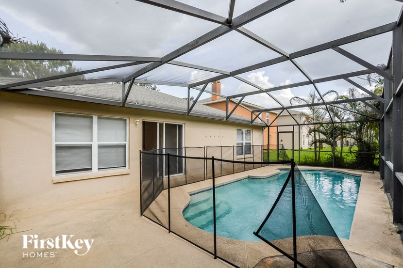 A pool under a black metal roof.