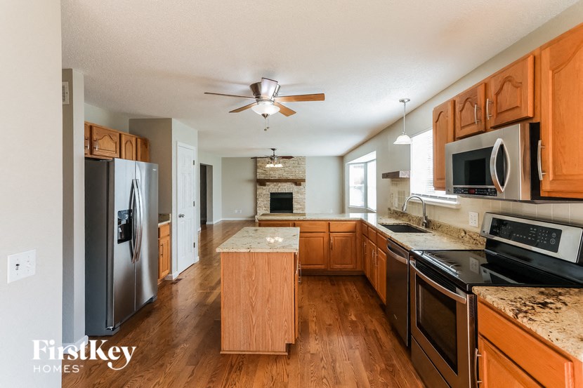 a kitchen with wooden cabinets and stainless steel appliances