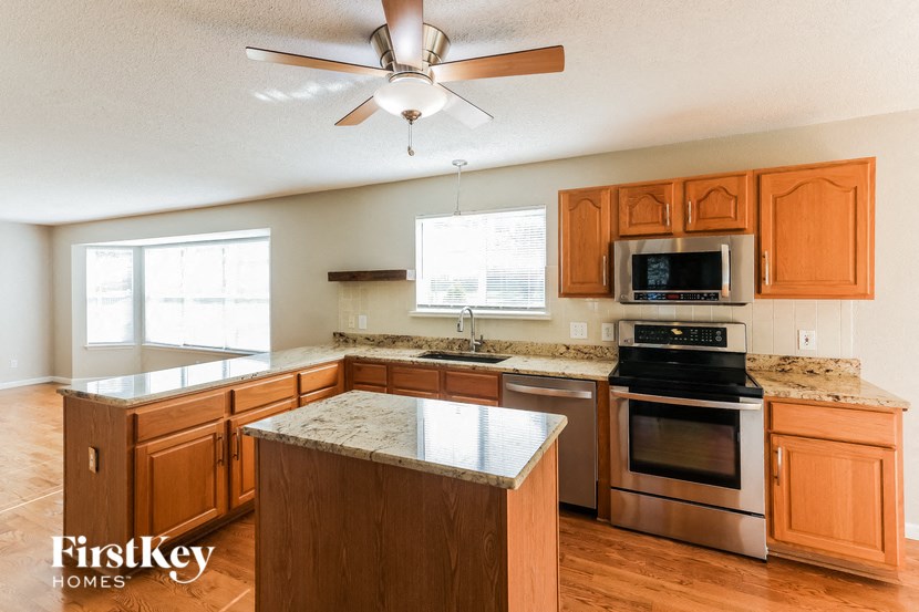 a kitchen with wooden cabinets and stainless steel appliances