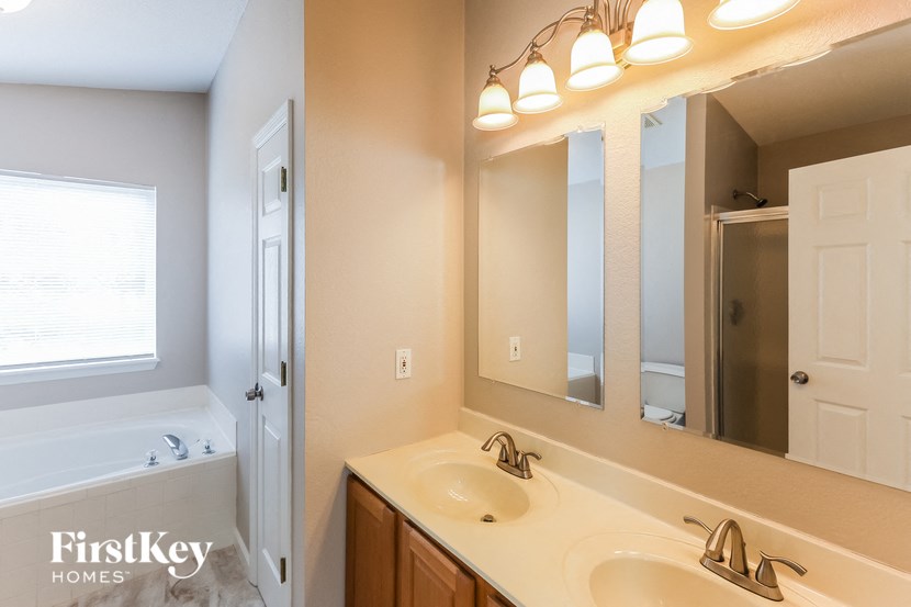 a bathroom with two sinks and a large mirror