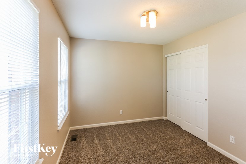 a room with a carpeted floor and a white door