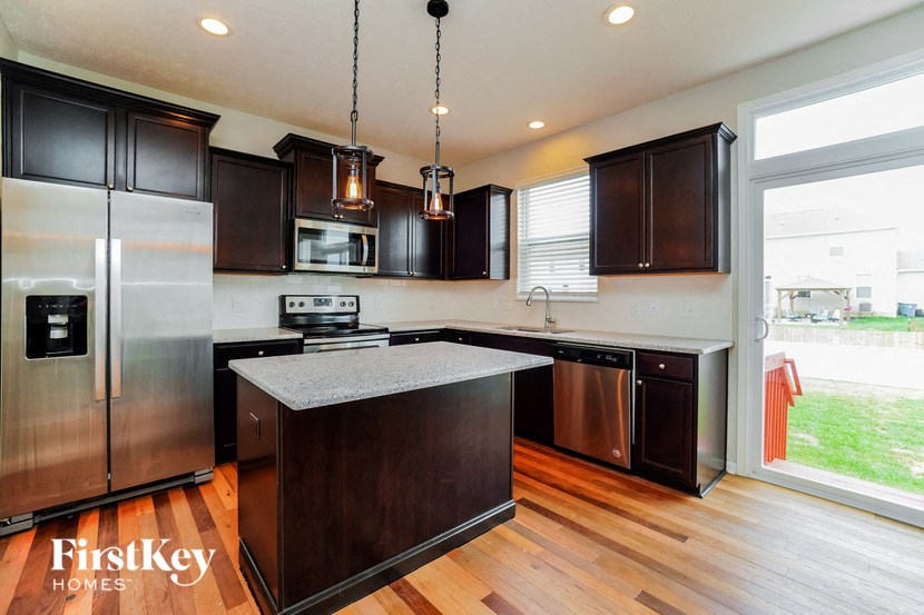 a kitchen with stainless steel appliances and a large window