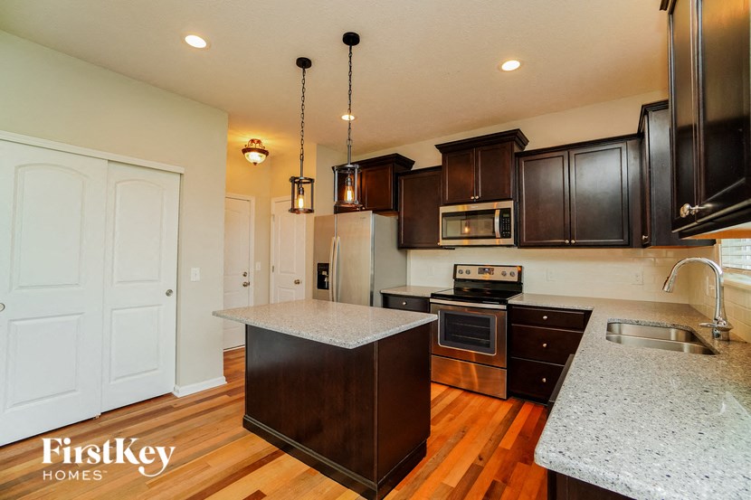 a kitchen with black cabinets and a white counter top