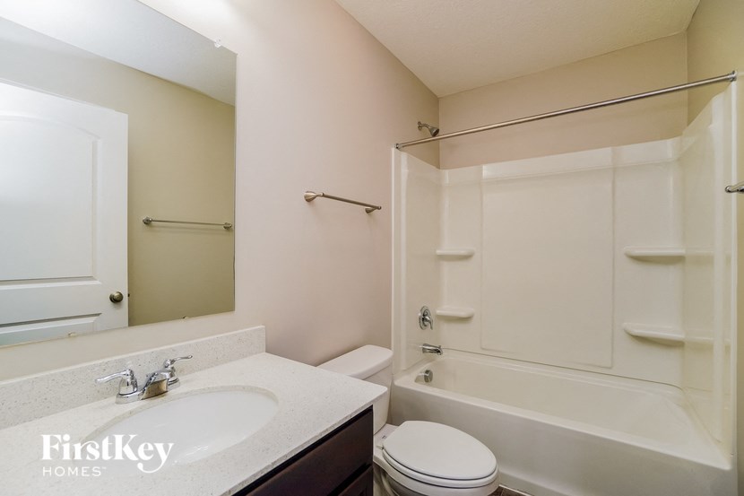 a bathroom with a sink toilet and a shower