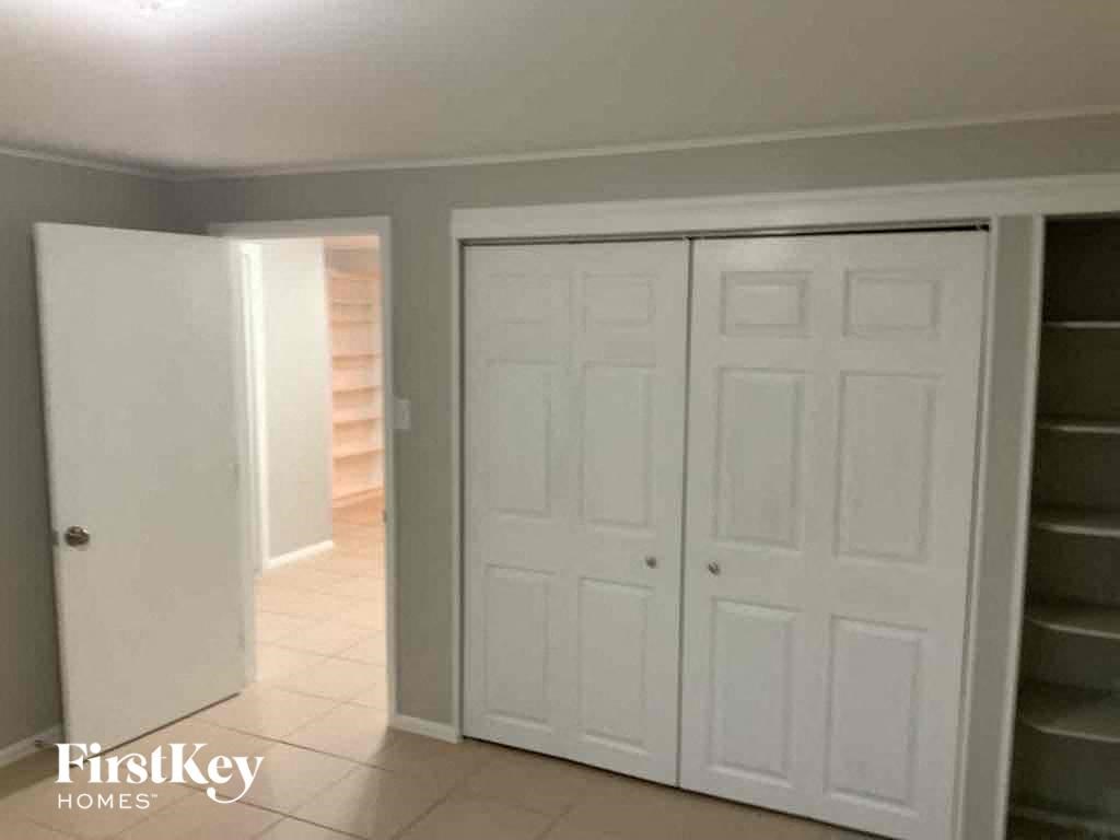 a closet with two closets and a staircase in a room