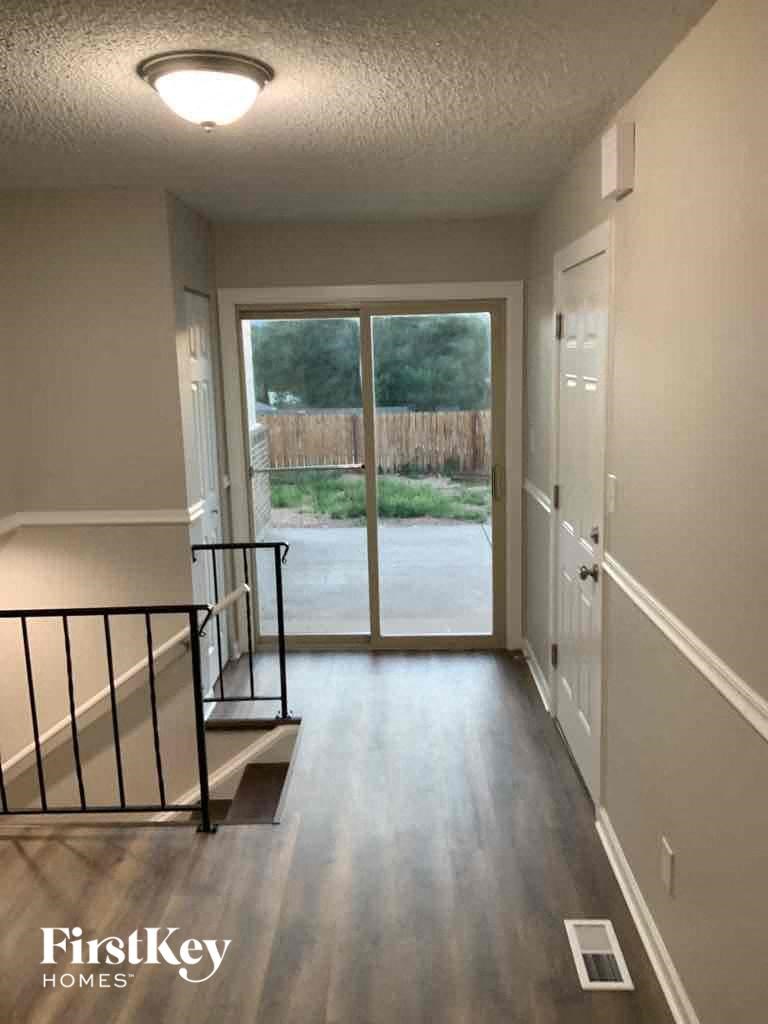 a view of a hallway from a house with a door to a patio