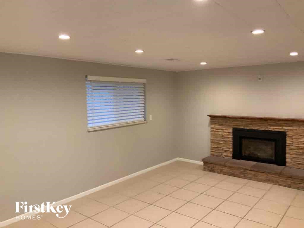 a living room with a fireplace and a tile floor