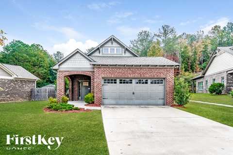 a brick house with a garage and a driveway