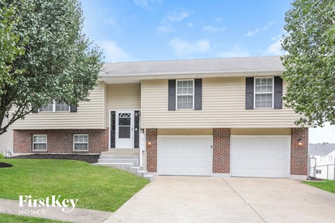 a beige house with a white garage door