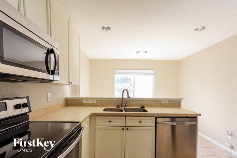 A kitchen with a stove top oven and a microwave.
