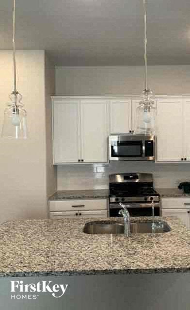 a kitchen with a sink and a microwave