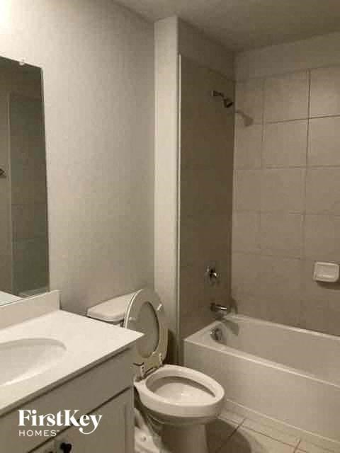 a bathroom with a toilet and a sink and a bath tub