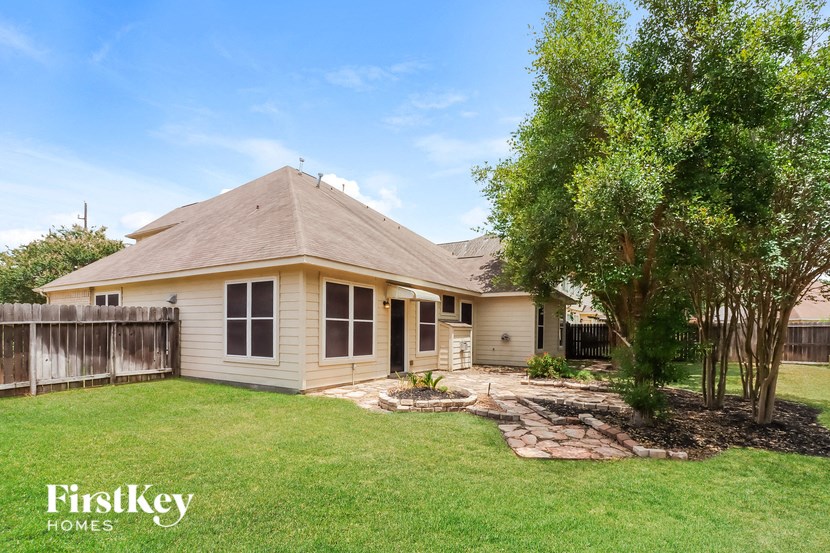 a small house with a yard and a tree