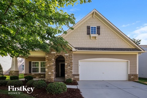 the front exterior of a house with a garage door