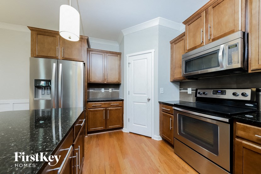 a kitchen with stainless steel appliances and wooden cabinets