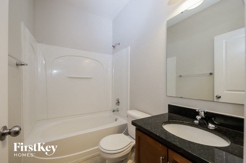 a bathroom with a sink toilet and a bath tub