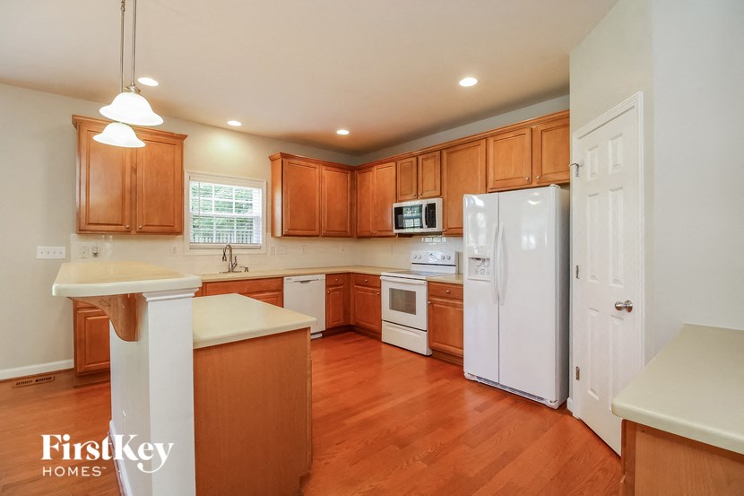 a kitchen with wooden cabinets and white appliances