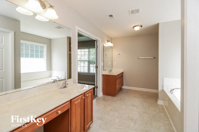 a large bathroom with a sink and a mirror