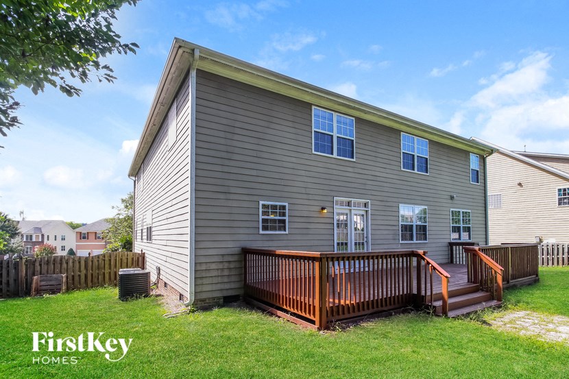 a house with a deck and a fenced in yard