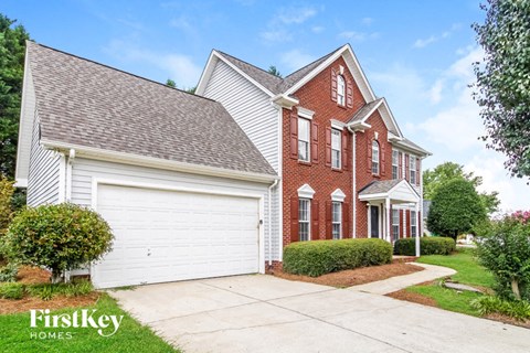 a brick and with a white garage door